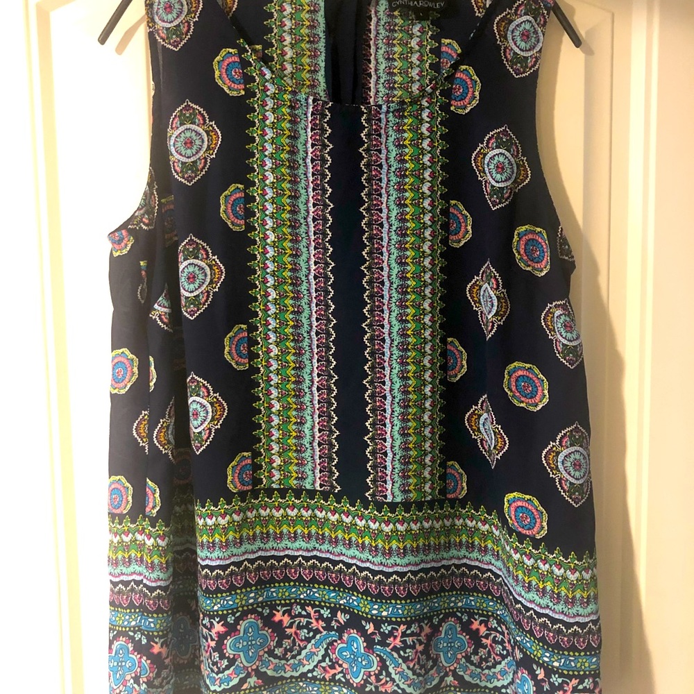 Sleeveless top, buttons down back.